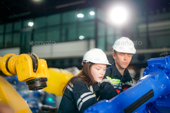 Engineer testing a robotic production simulator in robotics research ...