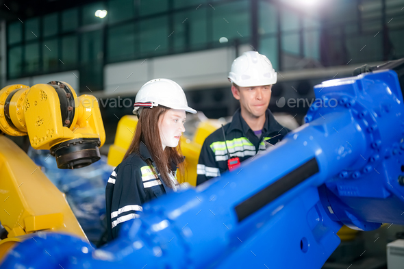 Engineer testing a robotic production simulator in robotics research ...