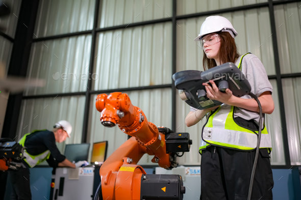 Engineer testing a robotic production simulator in robotics research ...