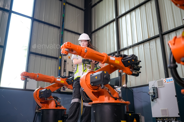 Engineer testing a robotic production simulator in robotics research ...
