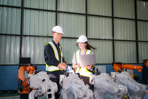 Engineer testing a robotic production simulator in robotics research ...