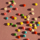festive pink background with scattered small multicolored stars. confectionery sprinkles - PhotoDune Item for Sale
