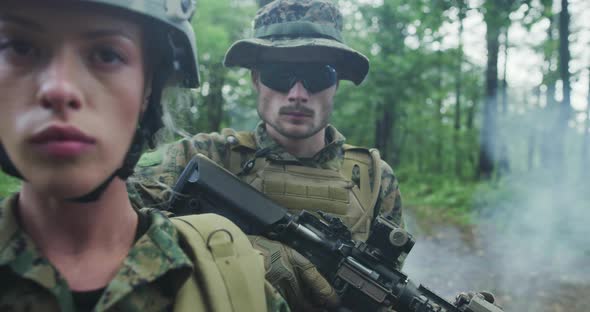 Squad of Soldiers Patrolling Across the Forest Area Team with Male and Female Soliders in Dense alt