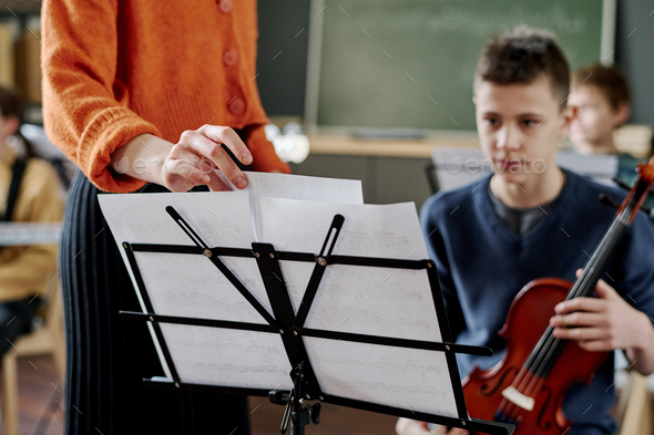 Unrecognizable Teacher Working With School Orchestra