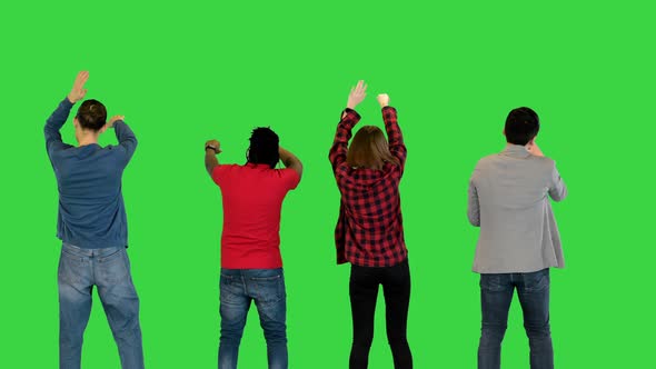 Multiethnic Group of Young Friends Dancing on a Green Screen Chroma Key