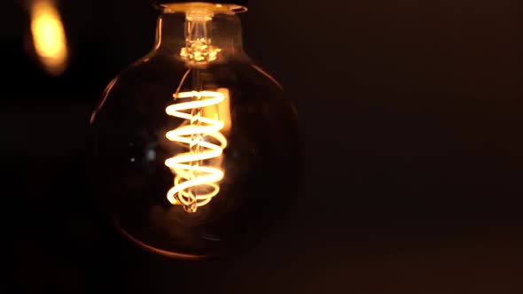 Tungsten Light Bulb Lamps Over Black Background alt