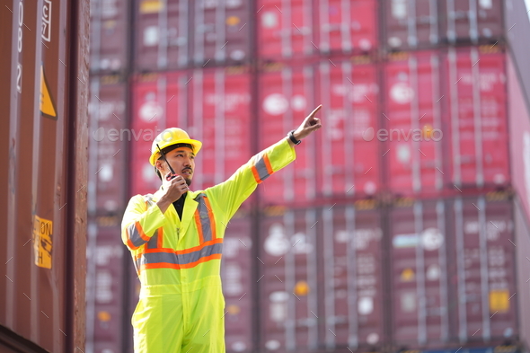 Foreman control loading Containers box from Cargo freight ship for import export. - Stock Photo - Images