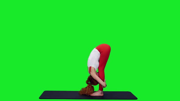 Fit Flexible Woman Standing Forward Bend In Yoga Posture On Green Screen