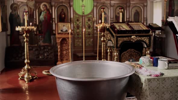 baptismal bowl in church with holiday candles