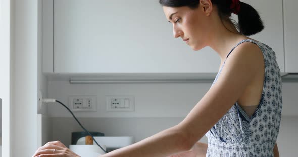 young woman cooks lit by the sun