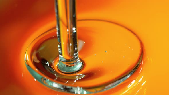 Super Slow Motion Shot of Pouring Golden Gel Liquid at 1000Fps. alt