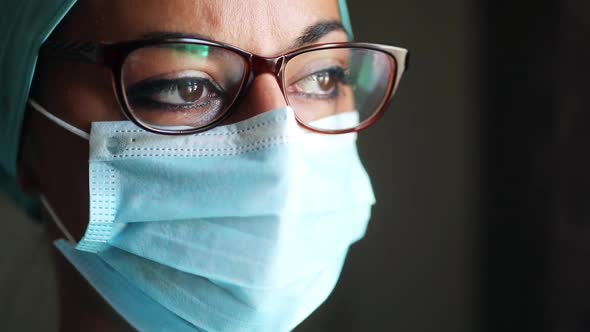 Young female medic, wearing a mask and glasses