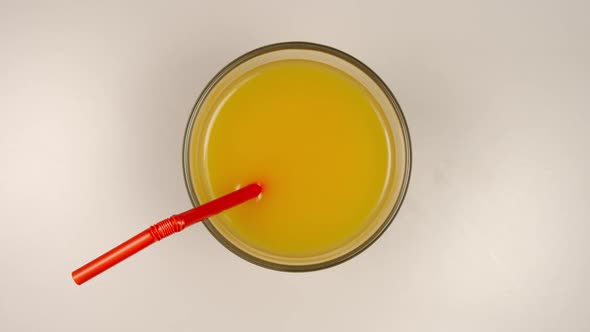 Drinking a fresh orange juice by a straw