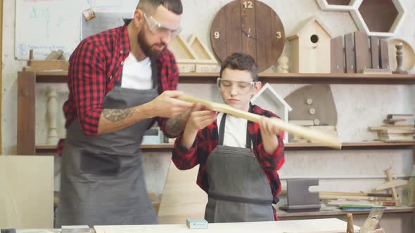 Little Male Woodworker Creating His Dream and His Dad Is Helping Him
