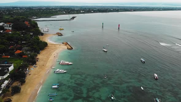 Beautiful cinematic Sanur beach, Bali drone footage with interesting landscape, fishing boats, hotel alt