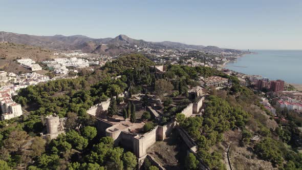 Aerial orbiting Gilbralfaro Castle on Hilltop, with panoramic views over Malaga Coastline. Spain