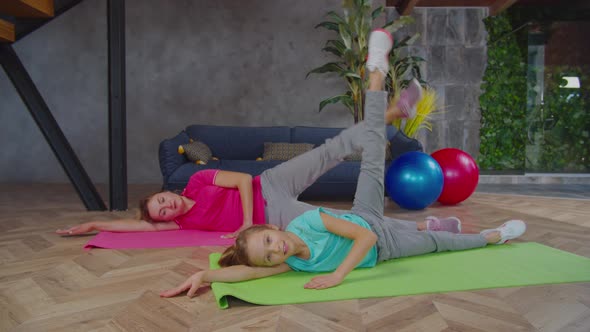 Sporty Fitness Mother and Kid Doing Side Leg Lift alt