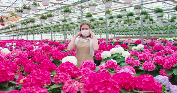 Smiling Woman Enjoying and Sniffing Pink Flowers alt