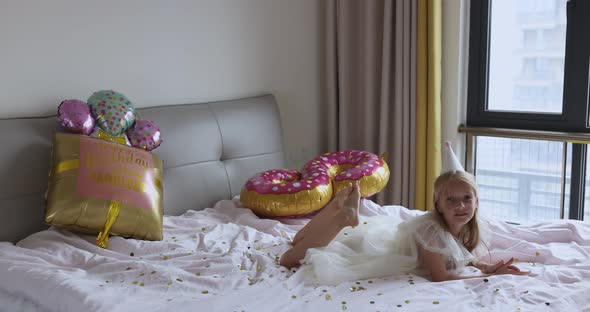 Indoor Shot of Pretty Joyful Cute Adorable Girl Kid Celebrating Eight Years Old Birthday with Bright alt