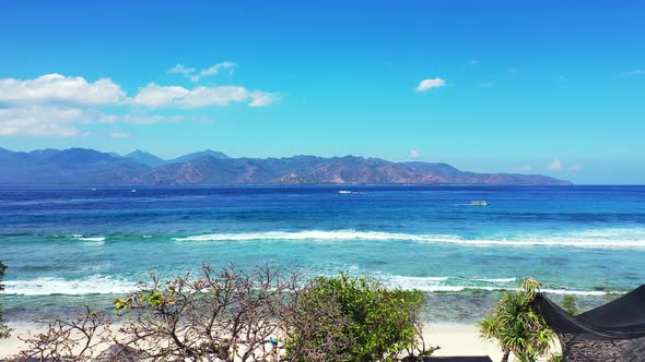 Wide overhead island view of a white sandy paradise beach and blue sea background in best quality 4K alt