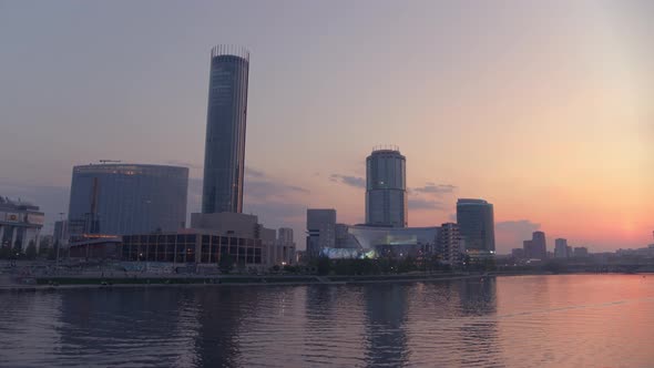 View From the Air at a Beautiful Pink Sunset Over the River in the City Centre alt
