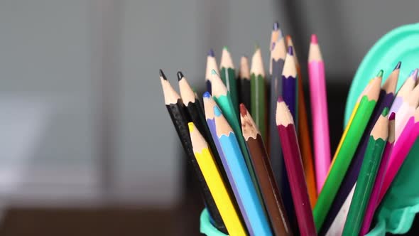 Colored Pencils For Drawing. They Stand In A Pencil Holder In The Form Of A Trash Can.