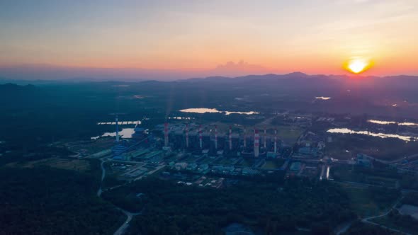 Aerial view over coal-fired power plant at sun dawn.