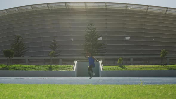 Front view of African american athlete throwing javelin alt