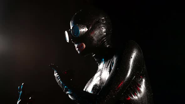 Anonymous Bdsm Lover Woman is Wearing Latex Suit and Full Face Mask is Dancing in Darkness alt