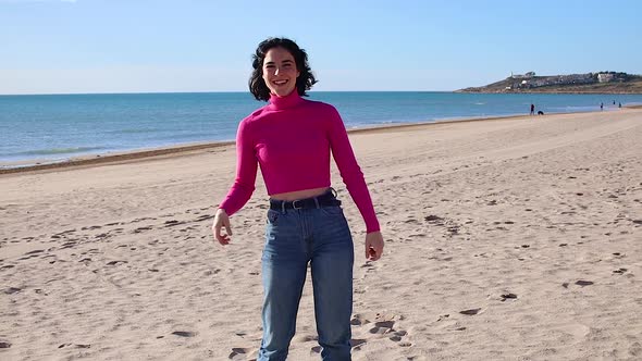 Young Woman Dancing on the Coastline and Laugh