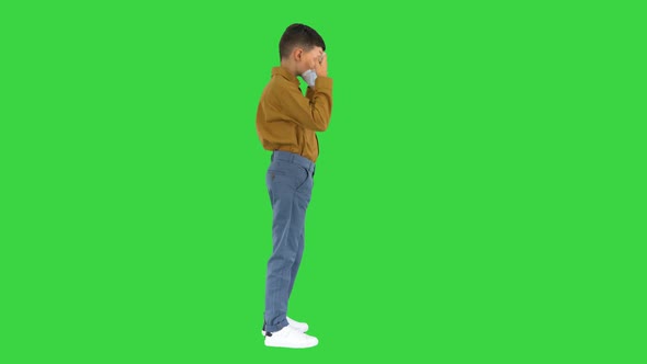 Little Boy Taking His Face Mask Off and Smiling at Camera on a Green Screen, Chroma Key alt