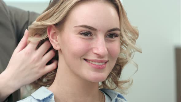 The Final Styling of Curly Hair of Model By Hairdresser in Beauty Salon alt