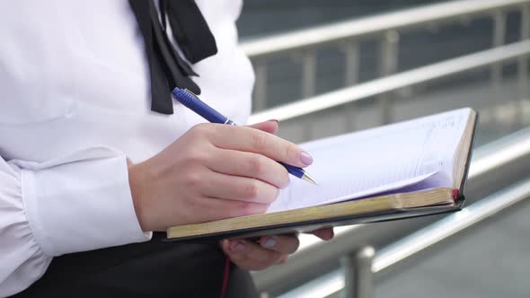 close-up, business woman looking plan in the diary