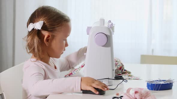 A Little Girl is Sewing