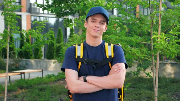 Camera Zoom in Smiling Young Man Courier Food Delivery with Thermal Backpack alt