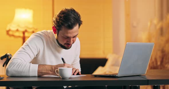 Middle Aged Businessman Sits in Wheelchair Being Disabled or Invalid Develops Business Project Write alt