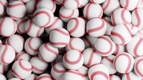 A large number of white baseball balls. Set of many professional sports balls. alt