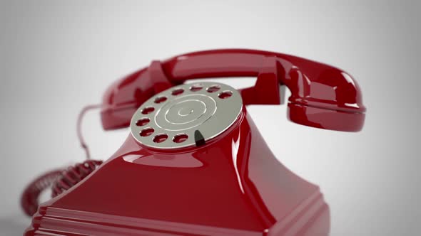 Zoom-out animation of a stylish vintage red telephone ringing endlessly ...