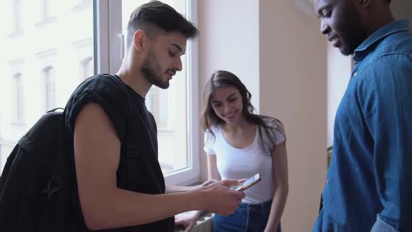 Students Holding Gadget, Talking in University Hall alt
