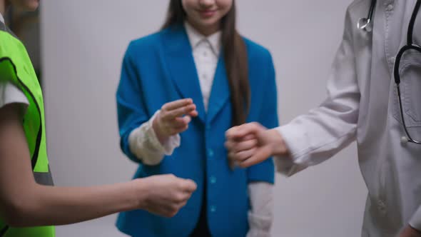 Unrecognizable Teenage Friends Playing Rock Paper Scissors at White Background alt