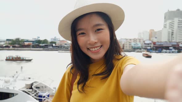 Beautiful Asian woman taking selfies on a smartphone.