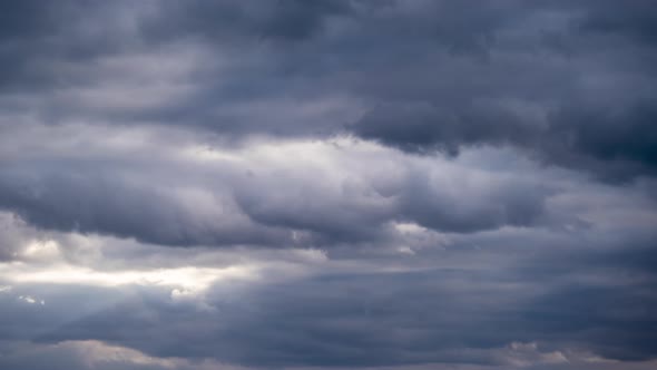 Dramatic Cumulus Storm Clouds Move in the Blue Sky. Sunbeams Shine. Time Lapse alt