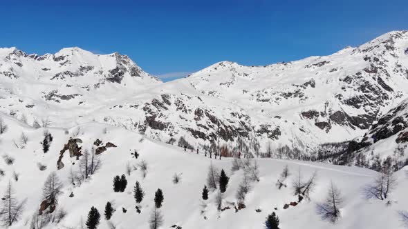 Group of ski touring on skin uphill in a line. Ski touring in big mountains alt