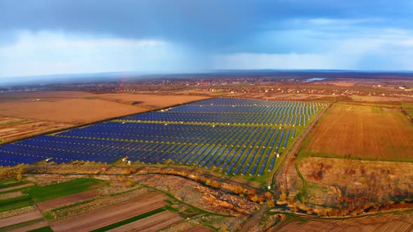 Renewable green energy Power Plant. Flyover Solar Panels Stands in a Row. Power Production alt
