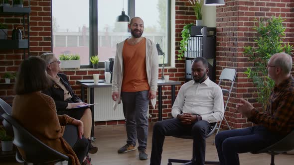 People Applauding Progress of Man with Addiction Issues at Aa Therapy Meeting alt