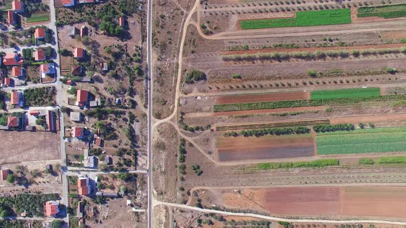 Aerial view of paved road dividing houses and fields, Dalmatia, Croatia alt