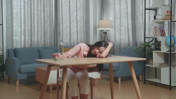 Drunk Asian Woman With Smartphone On Table Drinking Vodka And Sleeping At Home alt