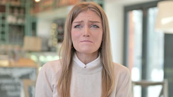 Portrait of Young Woman Crying at the Camera  alt