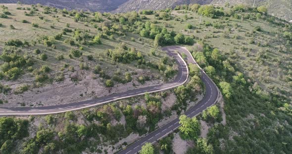 Aerial Top Down  View of Cars Driving on a Curvy Road on the Mountain