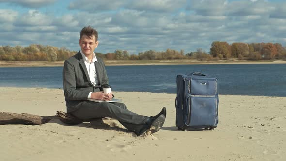 Businessman with a Laptop Suitcase Working Relaxing on the Beach